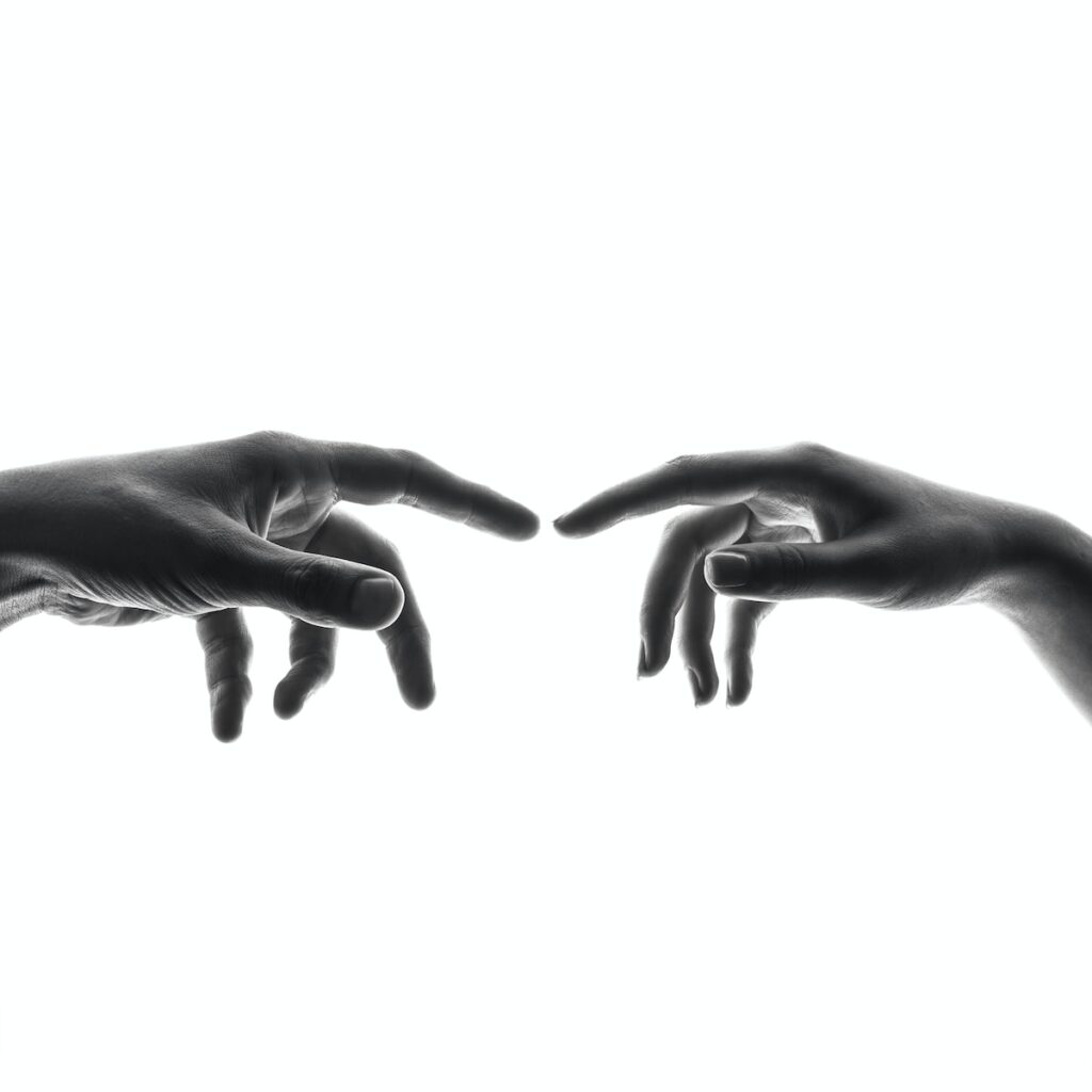 two person's connecting fingers